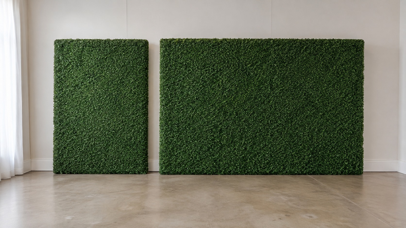 Two green boxwood walls of different widths side by side in the same event room