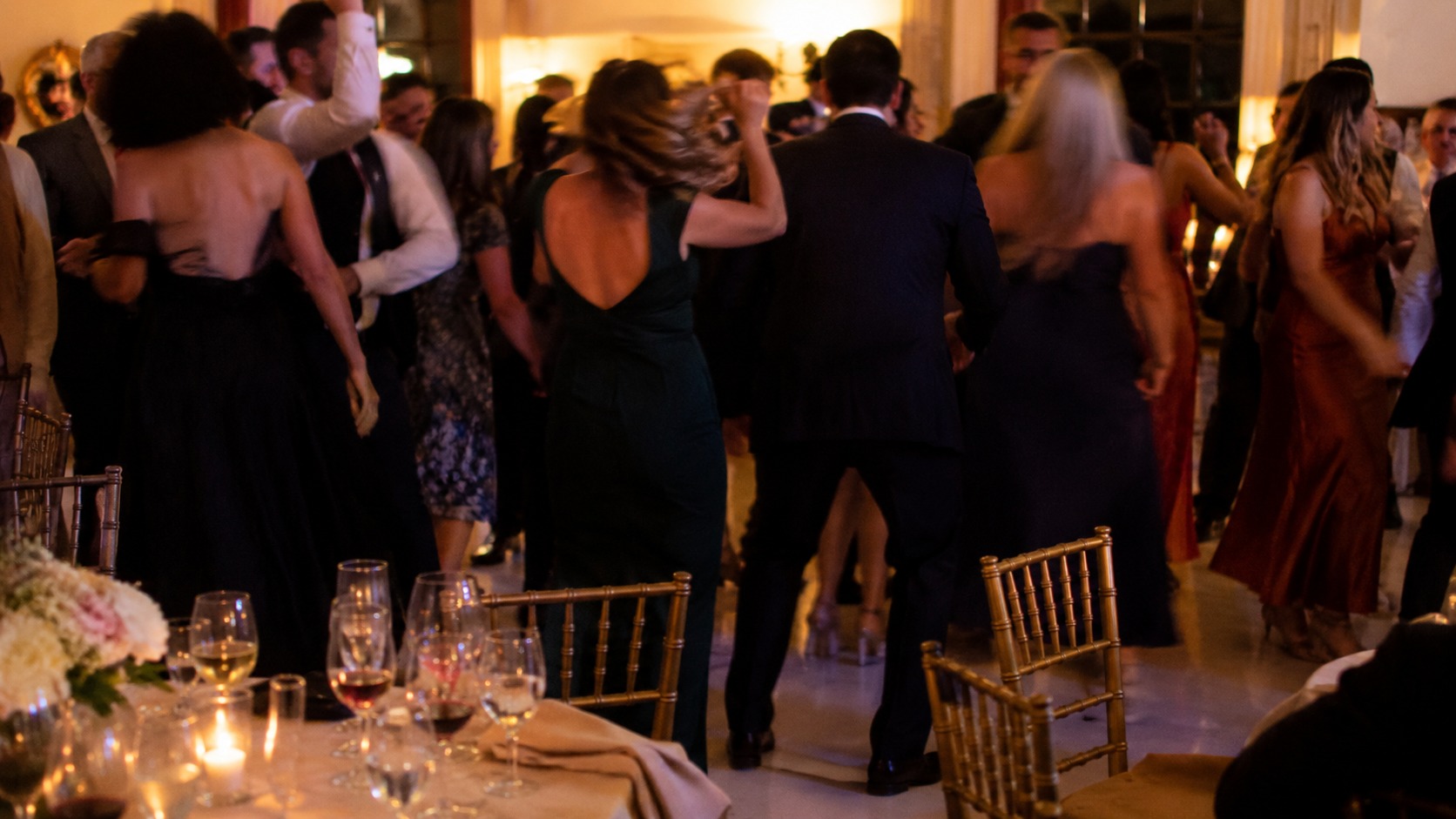 Guests dancing on a compact dance floor with the surrounding tables close by