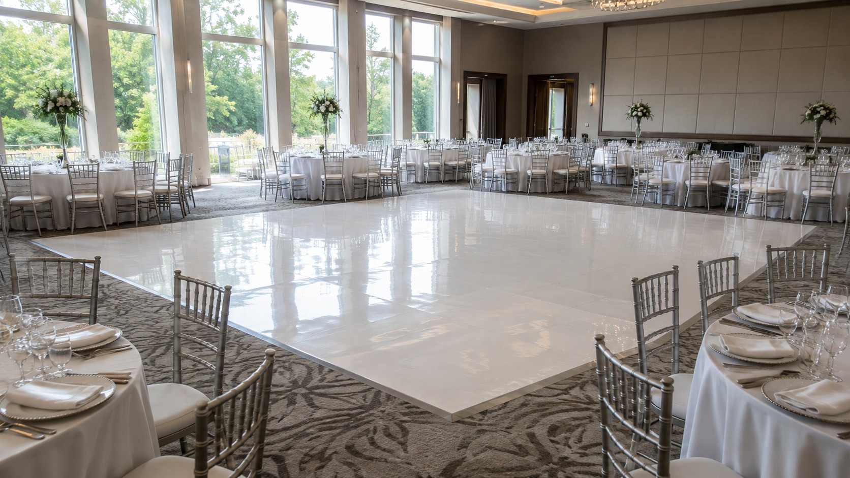 White custom wrapped vinyl dance floor laid in an event room with tables set around it
