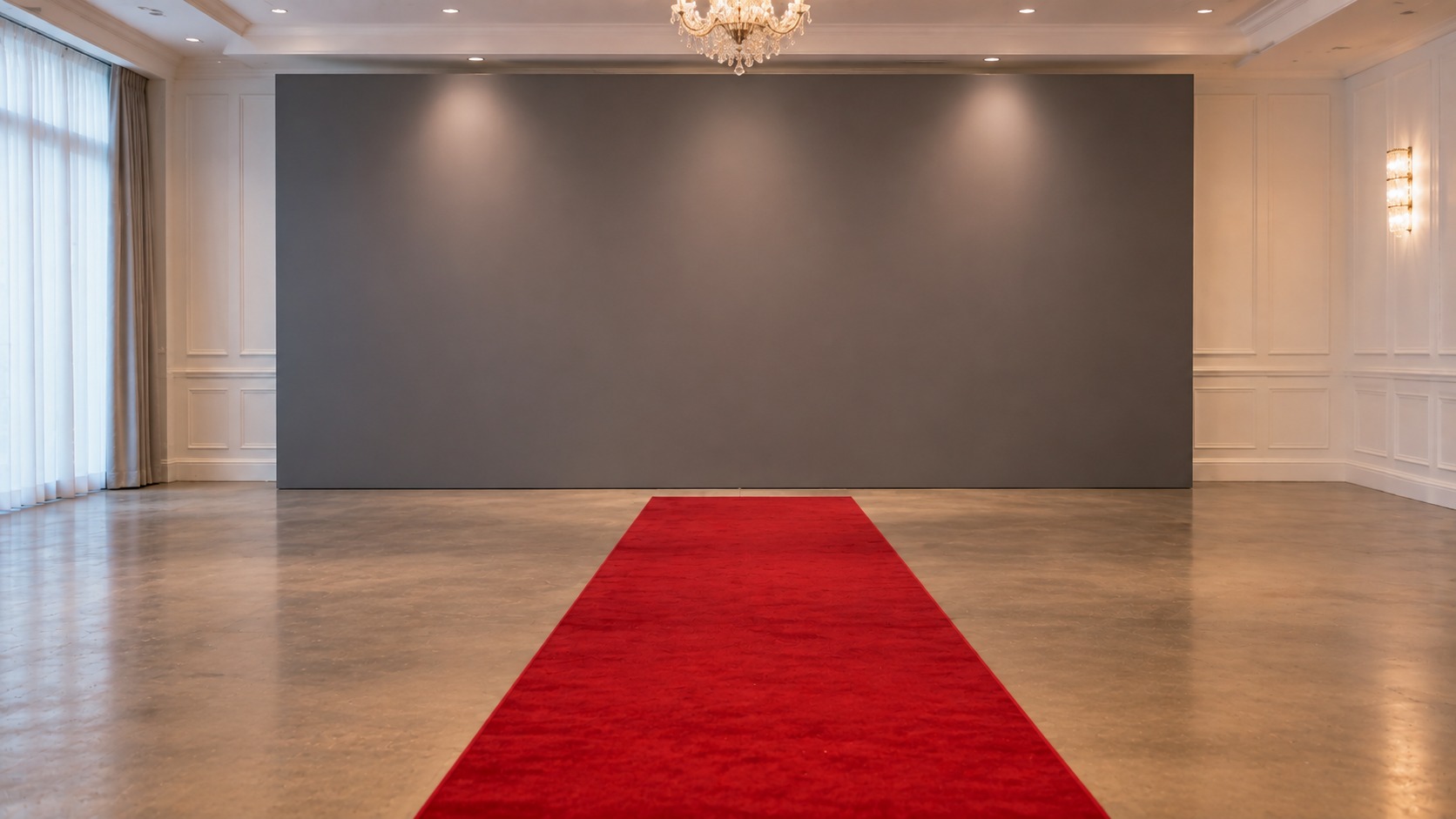 Red carpet ending at a plain event backdrop with clear open floor in front of it