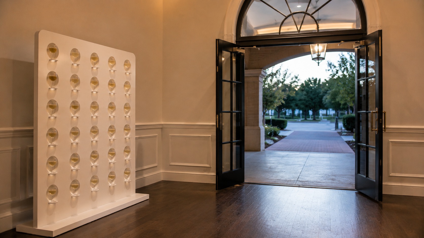 Champagne wall positioned to one side of a venue entrance with a clear walkway past it